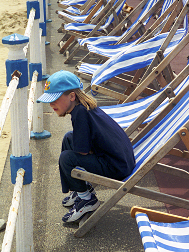 A girl amongst blue and white striped deck chairs on the promenade at Weymouth photographed by pop artist Trevor Heath